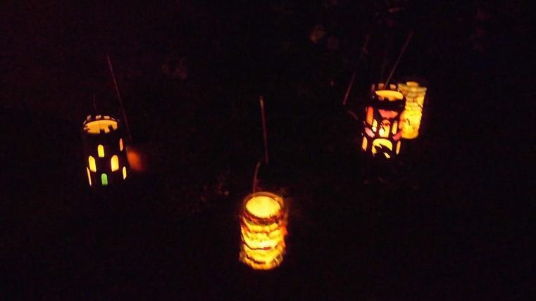Colorful lanterns light up the darkness. They are made of paper and have various patterns.