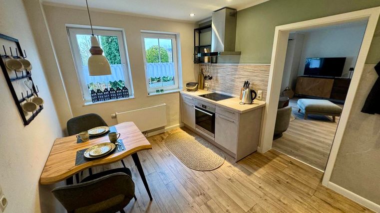 A modern and fully equipped kitchen invites you to cook and linger.