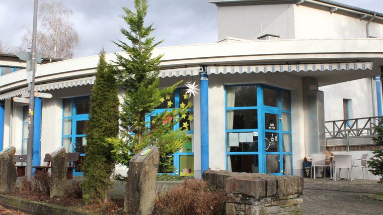 The exterior view of a café building with a focus on the entrance area 