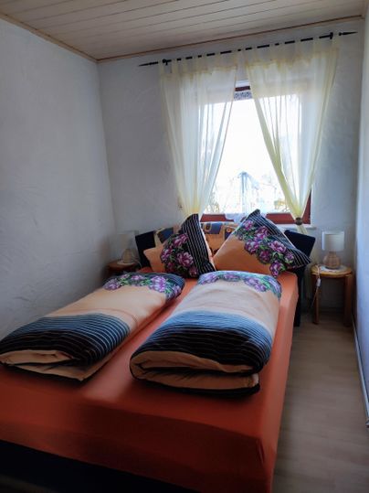 Bedroom with a queen-size bed, (if needed, two extra beds) and a large wardrobe.