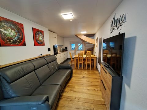 Das Erdgeschoss besteht aus einem modernen Wohnzimmer mit einem großen Sofa, einem Esstisch für vier Personen und einer modernen Küche. Der Großteil des Erdgeschosses ist mit Echtholzfußboden ausgelegt.