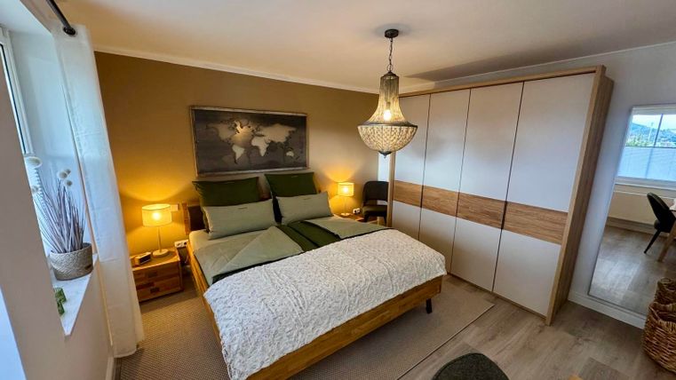 A cozy bedroom with a king-size bed, a wardrobe and high-quality mattresses for restful sleep and relaxation.