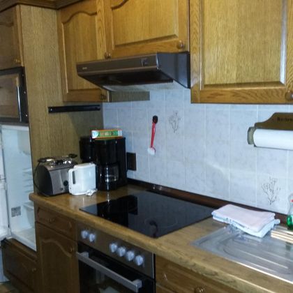 The kitchen is fully equipped except for a dishwasher.