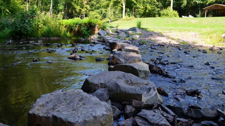 Stones in the river on the Kleine Kyll mindfulness trail.