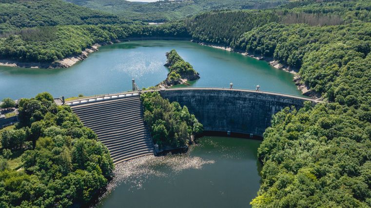 Vue aérienne du barrage de l'Urft avec le barrage de l'Urft entouré de forêt et d'eau.