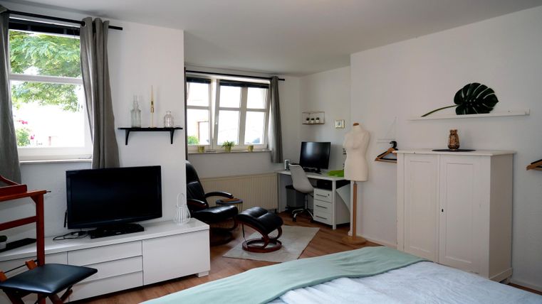 In the large bedroom, you have a massage chair and a workspace available to you.