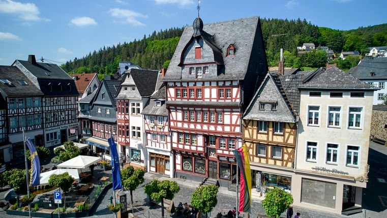 Zeile Fachwerkhäuser im Vordergrund der Marktplatz von Adenau 