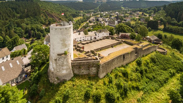 Aerial view of Reifferscheid Castle with surrounding landscape.