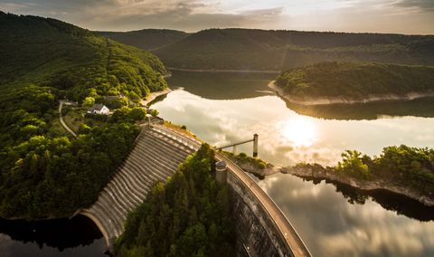 Aerial view of the Urft Dam in the Eifel National Park at sunset.