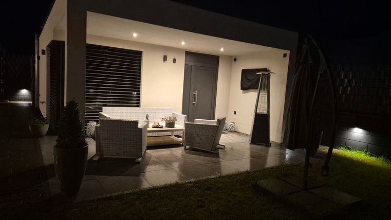 A modern terrace with comfortable furniture and soft lighting. The space is perfect for relaxing evenings outdoors.