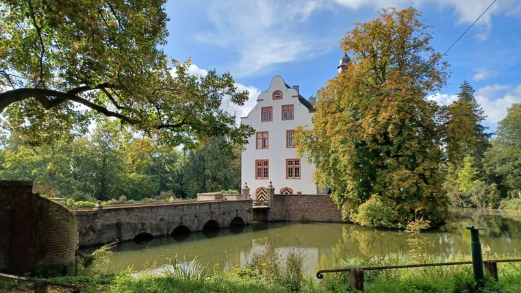 Metternich moated castle with bridge and trees in the fall.