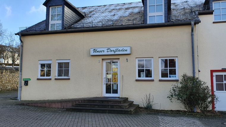 Entrance of a village store with sign 'Our village store'.