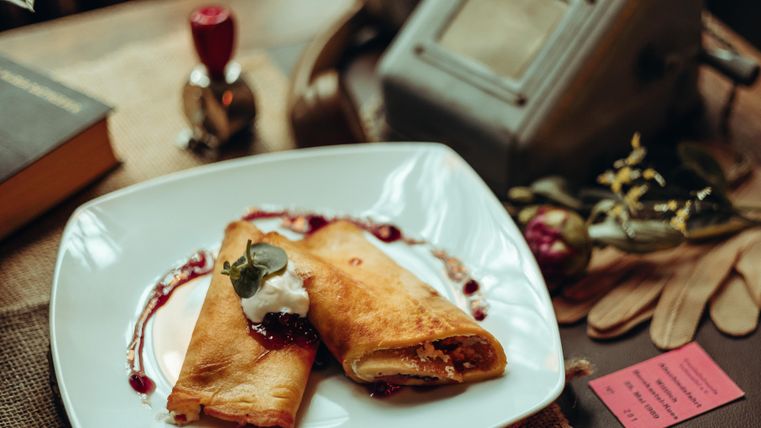 Gevulde, goudbruin gebakken pannenkoeken op een wit bord