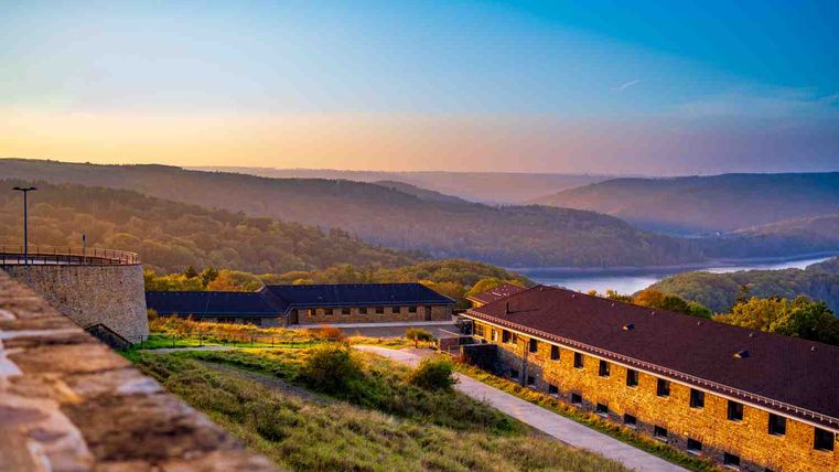 View of Vogelsang IP and the Urftsee lake in the Eifel at sunset.