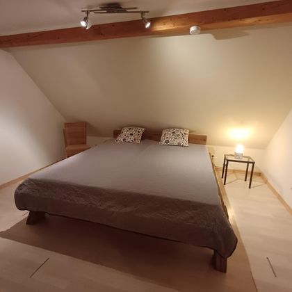 Das große 1,80 x 2,00 m Bett in unserer Ferienwohnung mit Blick auf die Eifellandschaft.