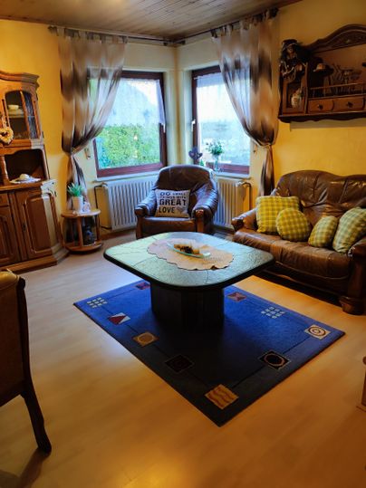 A cozy living room. Enjoy relaxed hours on the comfortable sofa after an eventful vacation day. A smart TV is available for your entertainment. The adjacent, spacious dining area invites you to enjoy shared meals or cozy game nights.