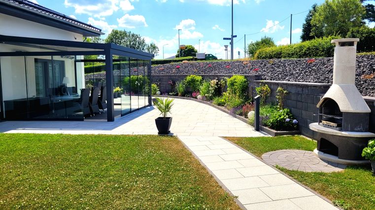 Outdoor area with large terrace and grill.
