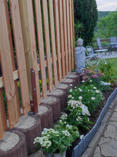 A well-maintained garden with flower beds and decorative elements.