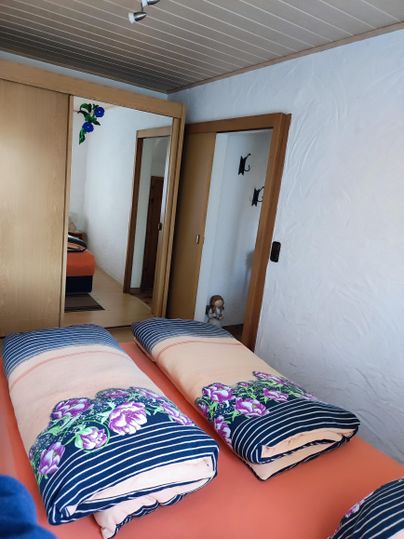 Bedroom with a queen-size bed, (if needed, two extra beds) and a large wardrobe.