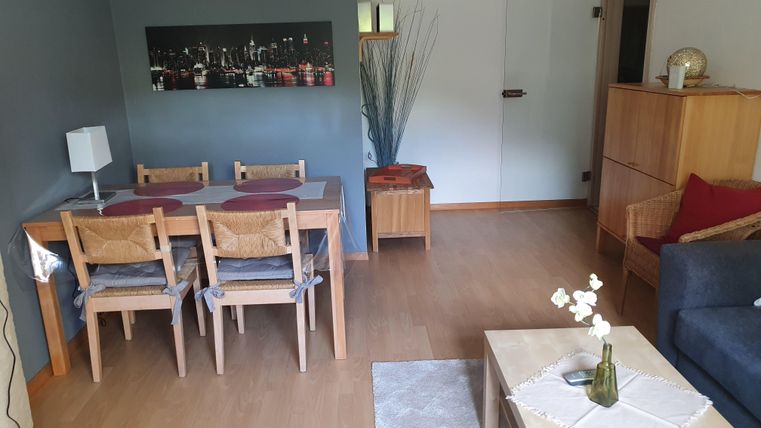 A cozy living space with a dining area and a sofa.