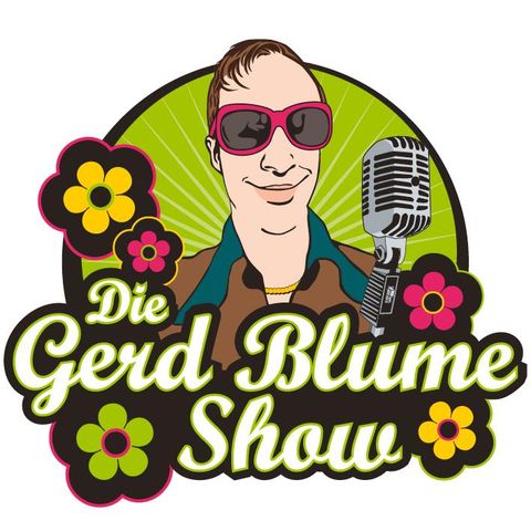 Ein lächelnder Mann mit kurzem Haar und Schnurrbart. Er trägt ein schwarzes T-Shirt und der Hintergrund ist dunkel.