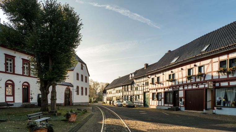 Market square in Olef with half-timbered houses and tracks of the Oleftalbahn.