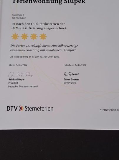 A certificate for the holiday apartment Slupek, awarded five stars. The document certifies the quality of the accommodation according to DTV standards.