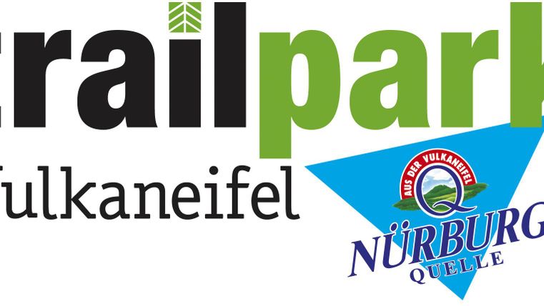 A logo of the Trailpark Vulkaneifel with clear colors and a modern design. The logo also includes the symbol for the Nürburg spring.
