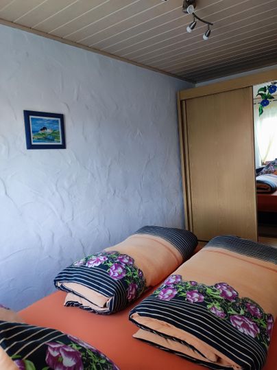 Bedroom with a queen-size bed, (if needed, two extra beds) and a large wardrobe.