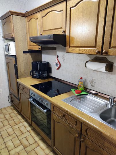 The kitchen is fully equipped except for a dishwasher.