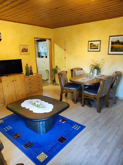 A cozy living room. Enjoy relaxing hours on the comfortable sofa after an eventful vacation day. A smart TV is ready for your entertainment. The adjacent, spacious dining area invites you to share meals or enjoy fun game nights together.