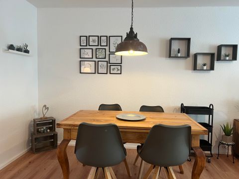 A stylish dining area with a extendable wooden table and modern chairs.