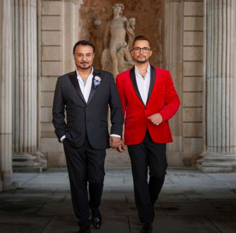 Two men are sitting in a room. They are smiling and seem to be having a good conversation.