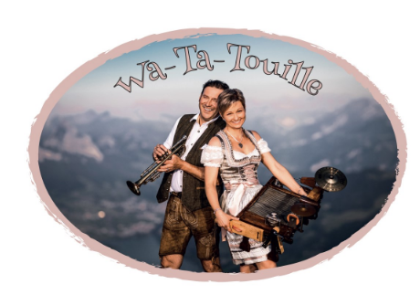 A couple in traditional attire stands in a beautiful mountain landscape. They are playing musical instruments and radiating joy.