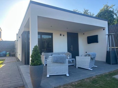 The furnishings include bright seating and plants that create an inviting atmosphere.