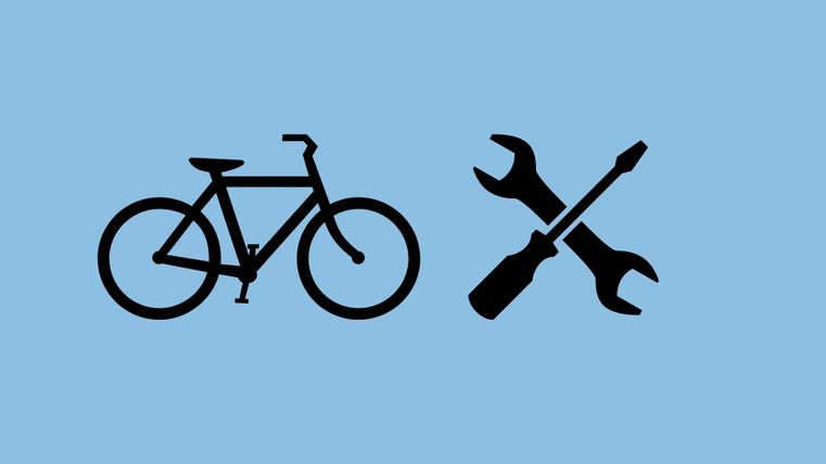 A bicycle with tools beside it. The symbols represent bicycle repair and maintenance.
