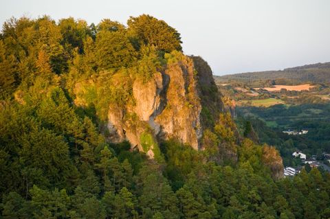 View of the wooded Gerolstein Dolomites in the sunlight.