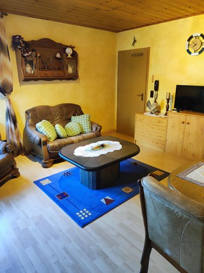 A cozy living room. Enjoy relaxing hours on the comfortable sofa after a day full of adventures. A Smart TV is available for your entertainment. The adjacent, spacious dining area invites you to share meals or enjoy fun game nights together.