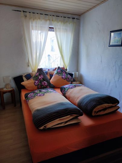 Bedroom with a queen-size bed, (optional two bedside beds) and a large wardrobe.